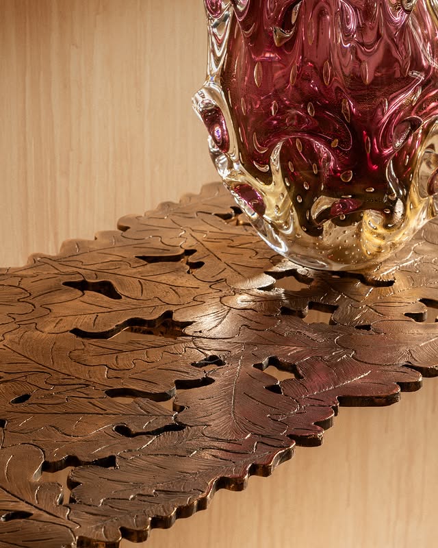 Close-up look at the oak leaves fused in bronze forming Osanna's Quercia Console.